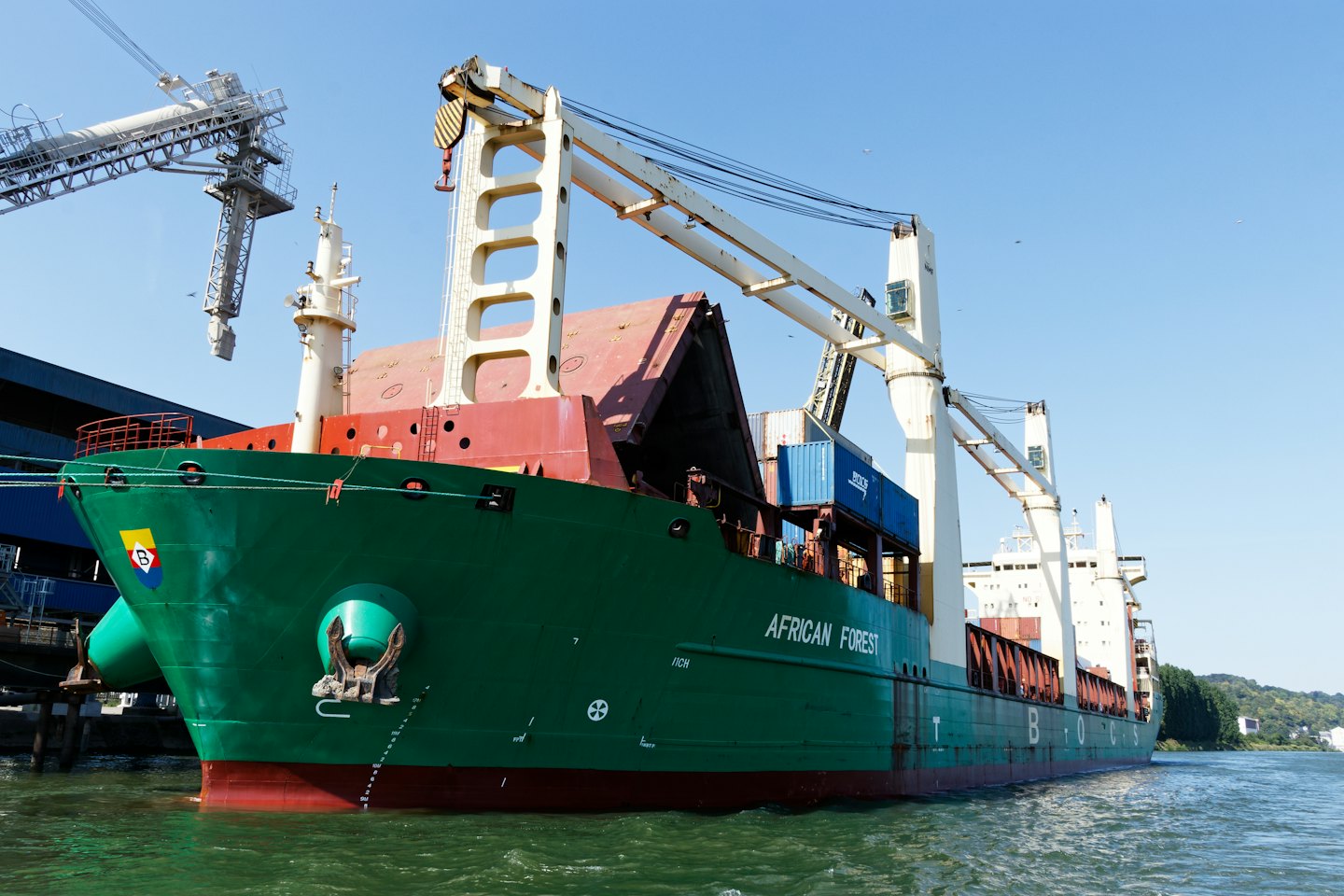 The cargo ship African Forest docks at an industrial port.